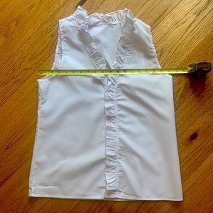 Ruffled white sleeveless blouse